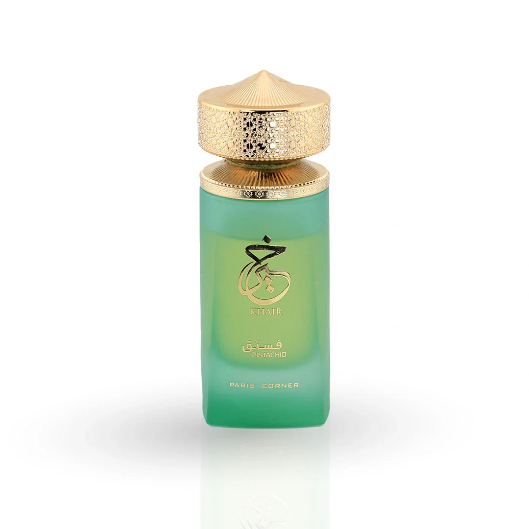 Khair Pistachio perfume in green gradient bottle with ornate gold filigree cap and tropical leaf packaging