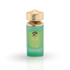 Khair Pistachio perfume in green gradient bottle with ornate gold filigree cap and tropical leaf packaging