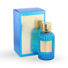 Ribbed blue glass perfume bottle with gold cap and tropical leaf label