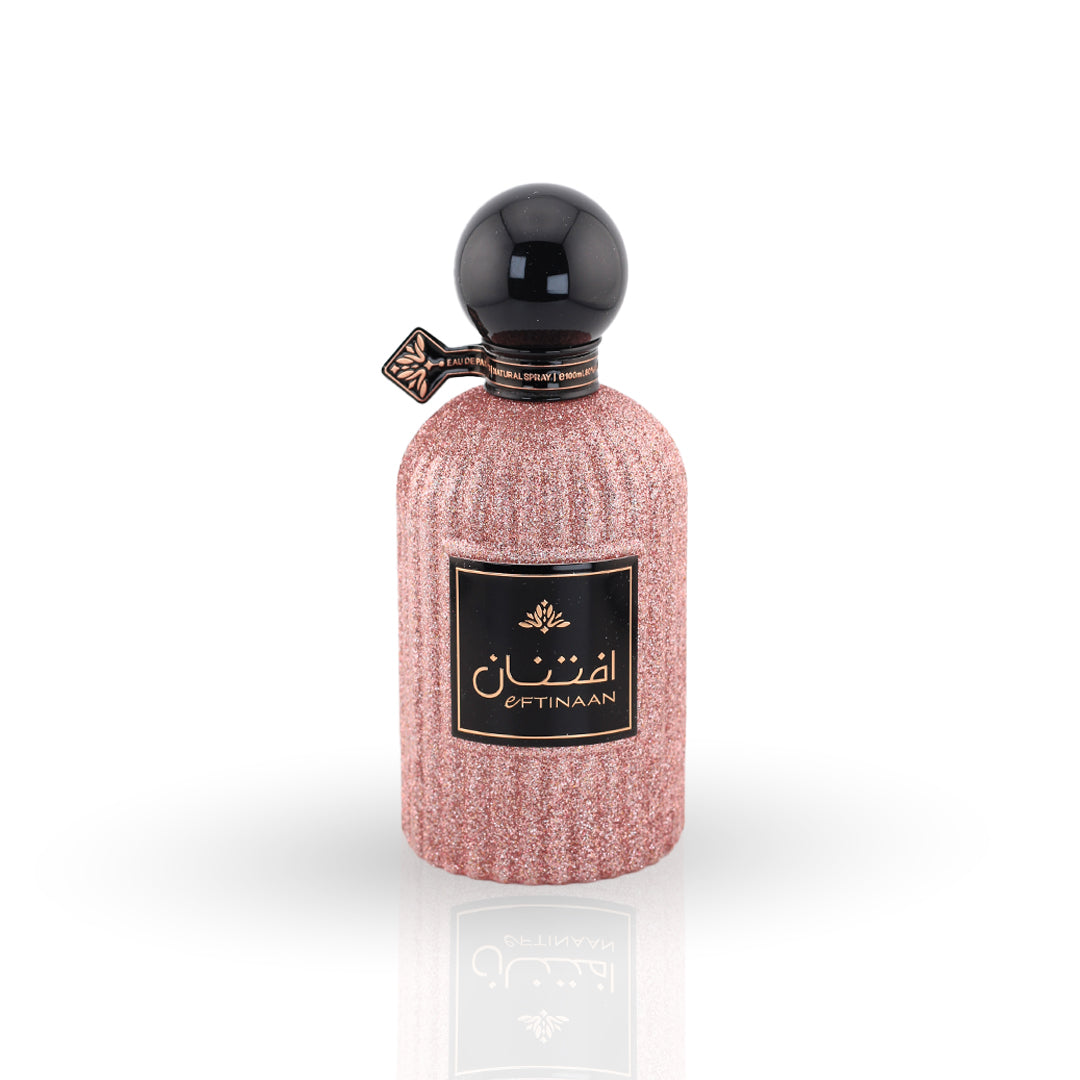 Perfume bottle with pink textured design and black cap on a white background