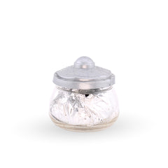 Glass jar with a silver lid on a white background
