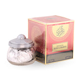 Jar of Bukhoor with its packaging on a white background