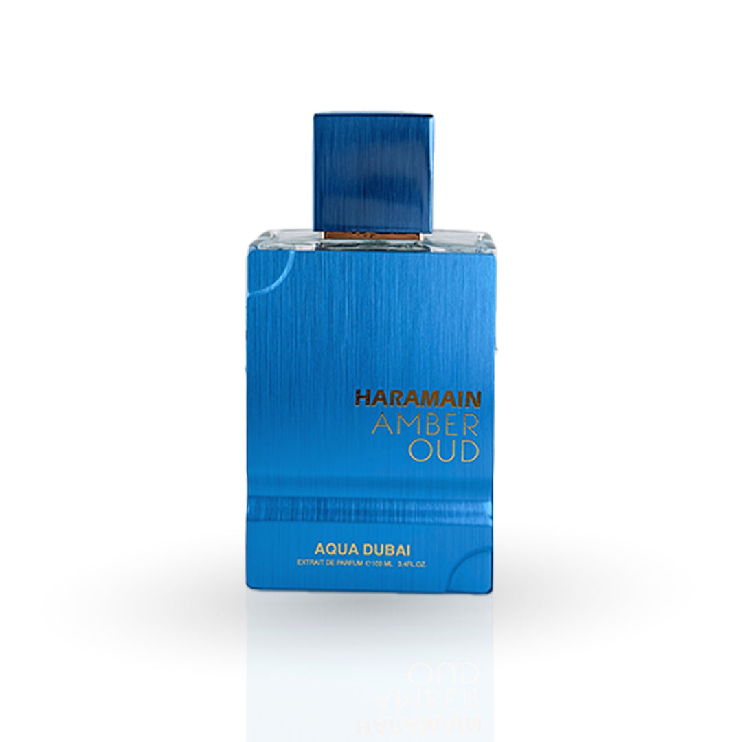 Blue perfume bottle labeled 'Haramain Amber Oud Aqua Dubai' on a white background