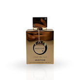 Gold perfume bottle with 'Milestone Club de Nuit' packaging on a white background