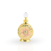 Gold and pink perfume bottle with decorative elements on a white background