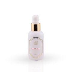 White dropper bottle with gold cap on a white background