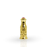 Gold decorative bottle cap with a red gemstone on a white background