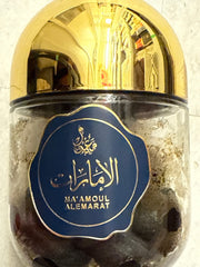 Gold and black container with a blue label featuring Arabic text on a white background