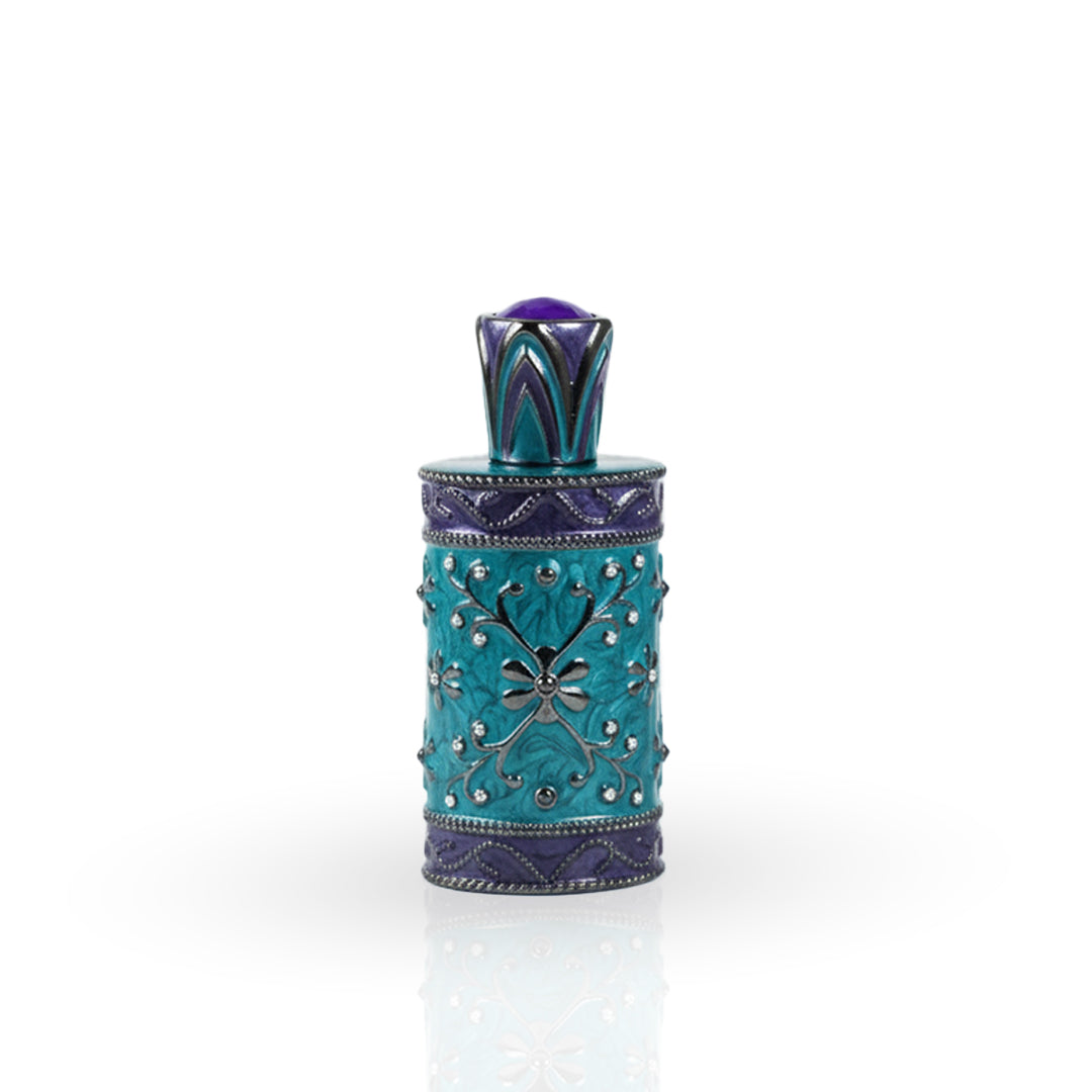 Decorative teal bottle with intricate designs on a white background