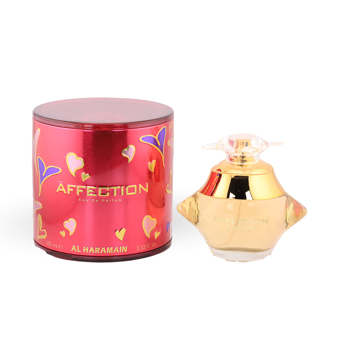 Al Haramain Affection Eau de Parfum 100ml — gold winged bottle beside its magenta round box with heart pattern