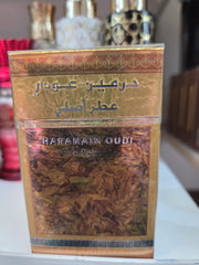 Al Haramain Oudi Pure Perfume bottle with golden oud wood design