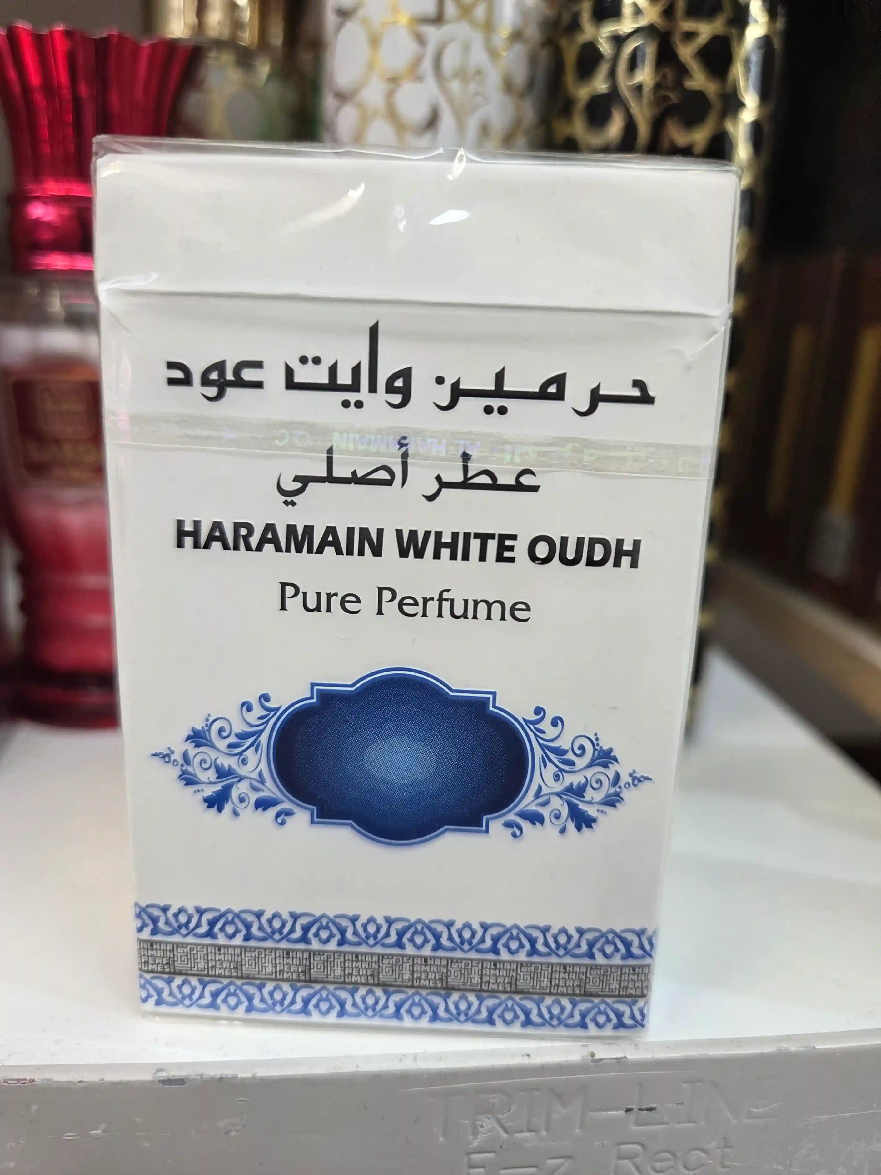 Al Haramain White Oudh Pure Perfume with elegant blue ornamental design