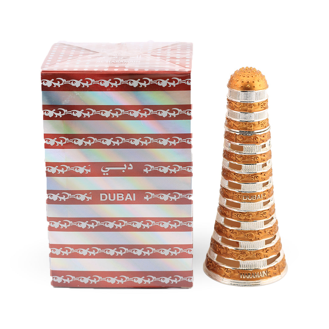 Decorative bottle with gold and silver design next to a striped box labeled 'Dubai'.