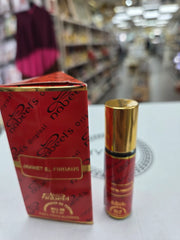 Jannet El Firdaus roll-on perfume bottle with red packaging and gold accents
