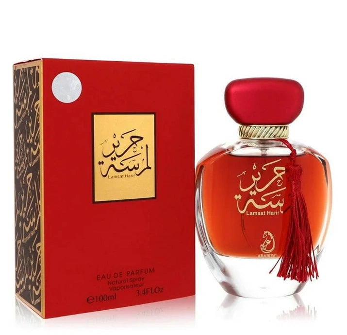 Lamsat Harir perfume in elegant red bottle with gold cap, decorative red tassel and matching packaging