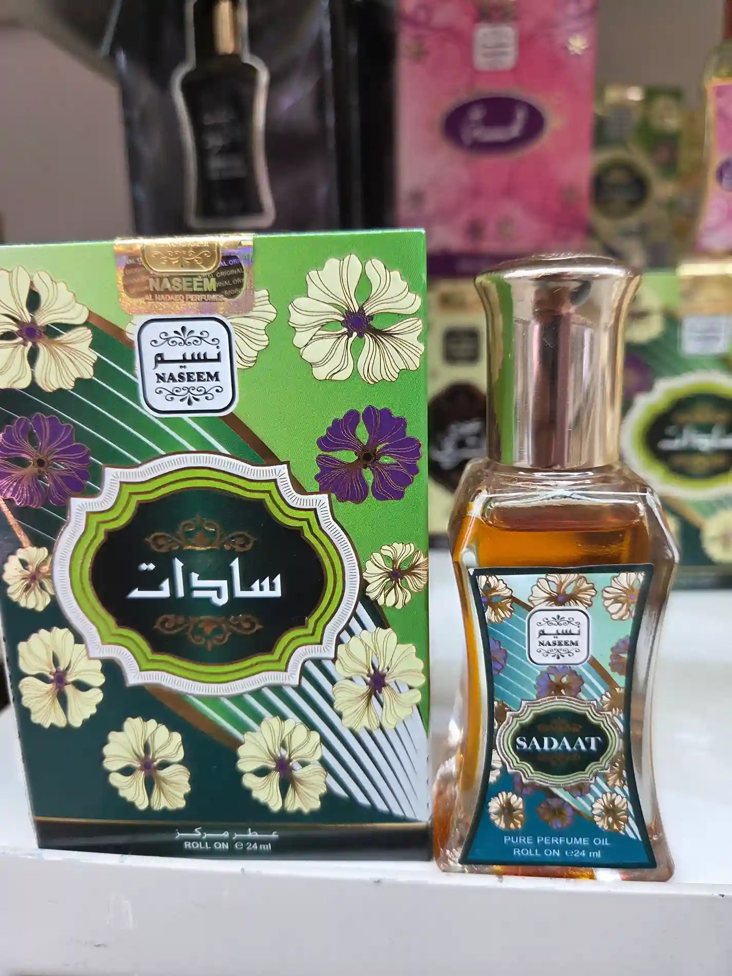 Naseem Sadaat roll-on perfume oil with green floral hibiscus packaging