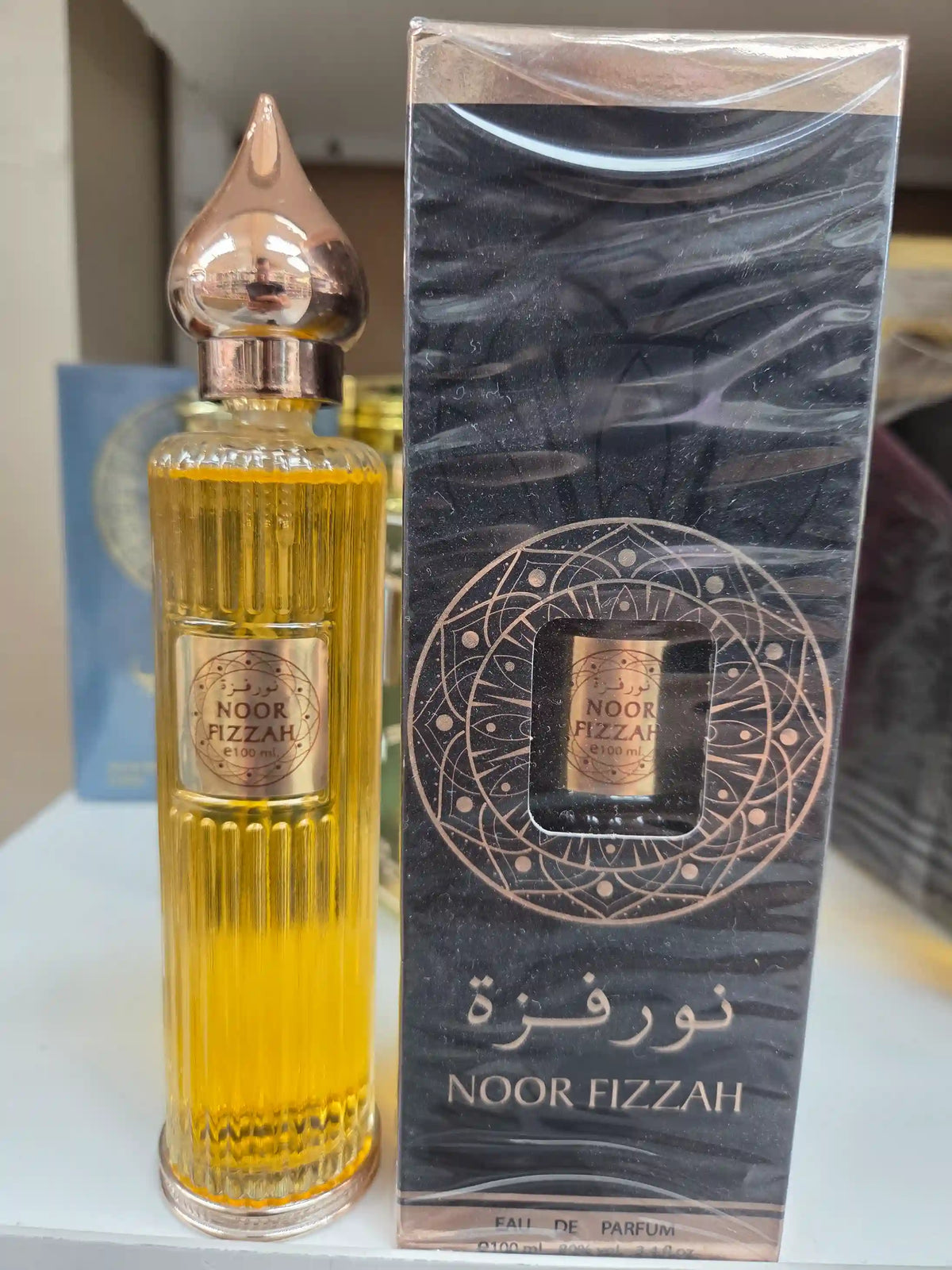 Noor Fizzah perfume 100ml golden amber fragrance with black marble packaging