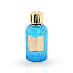 Ribbed blue glass perfume bottle with gold cap and tropical leaf label
