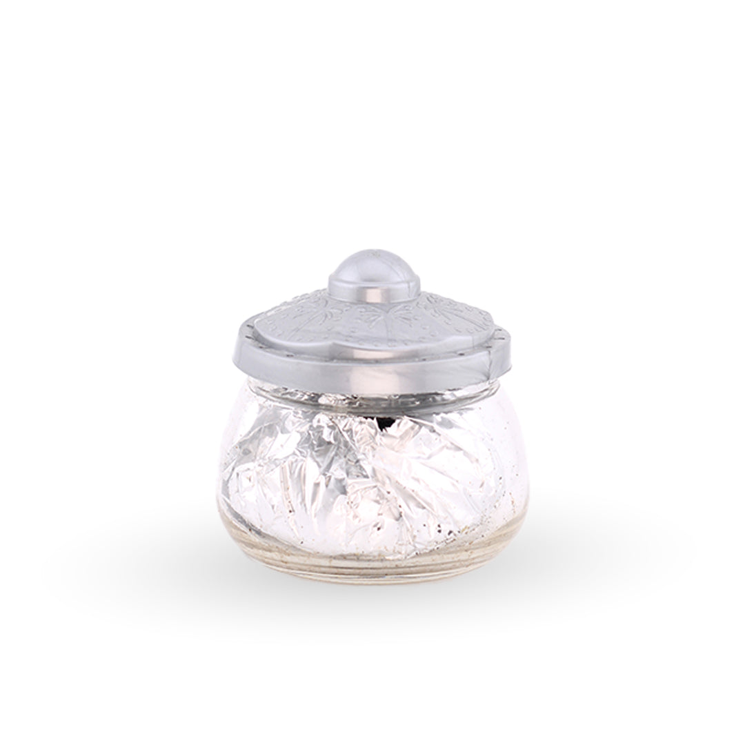 Glass jar with a silver lid on a white background
