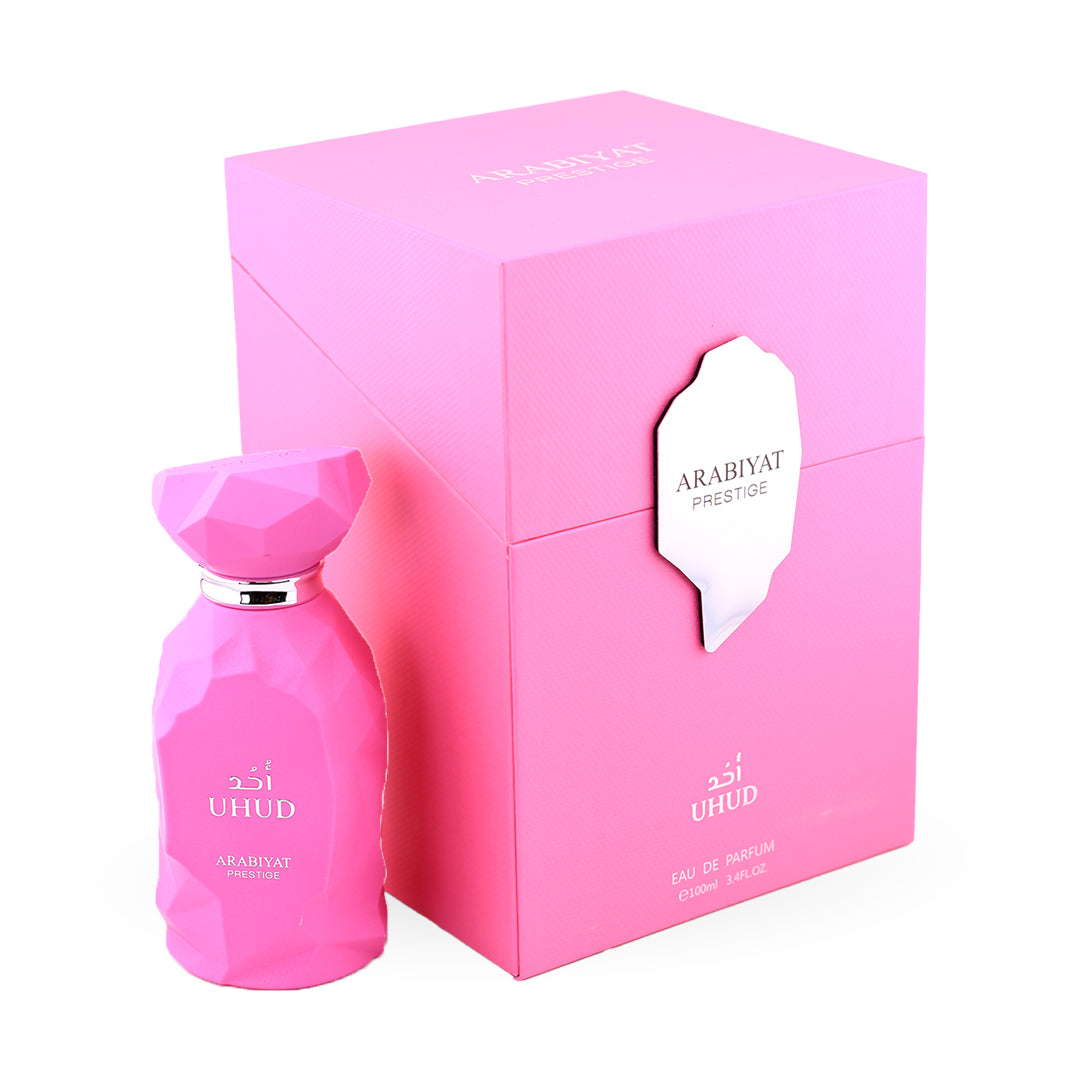 Pink perfume bottle and packaging with 'UHUD' branding on a white background