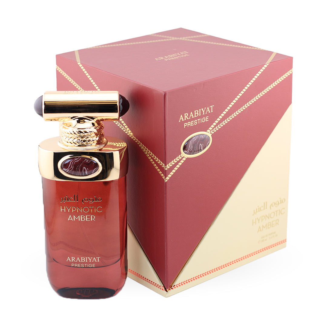 Red perfume bottle with gold accents and matching box labeled 'Arabiyat Prestige' on a white background