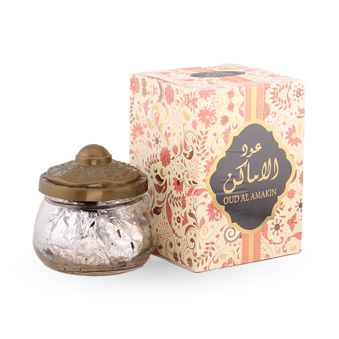 Decorative jar with a gold lid next to its packaging on a white background