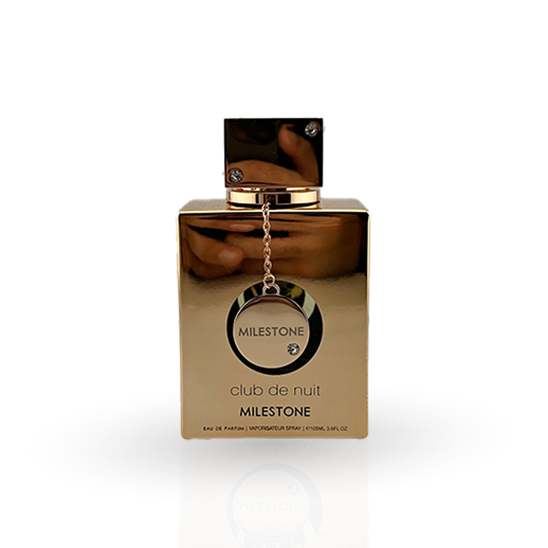 Gold perfume bottle with 'Milestone Club de Nuit' packaging on a white background