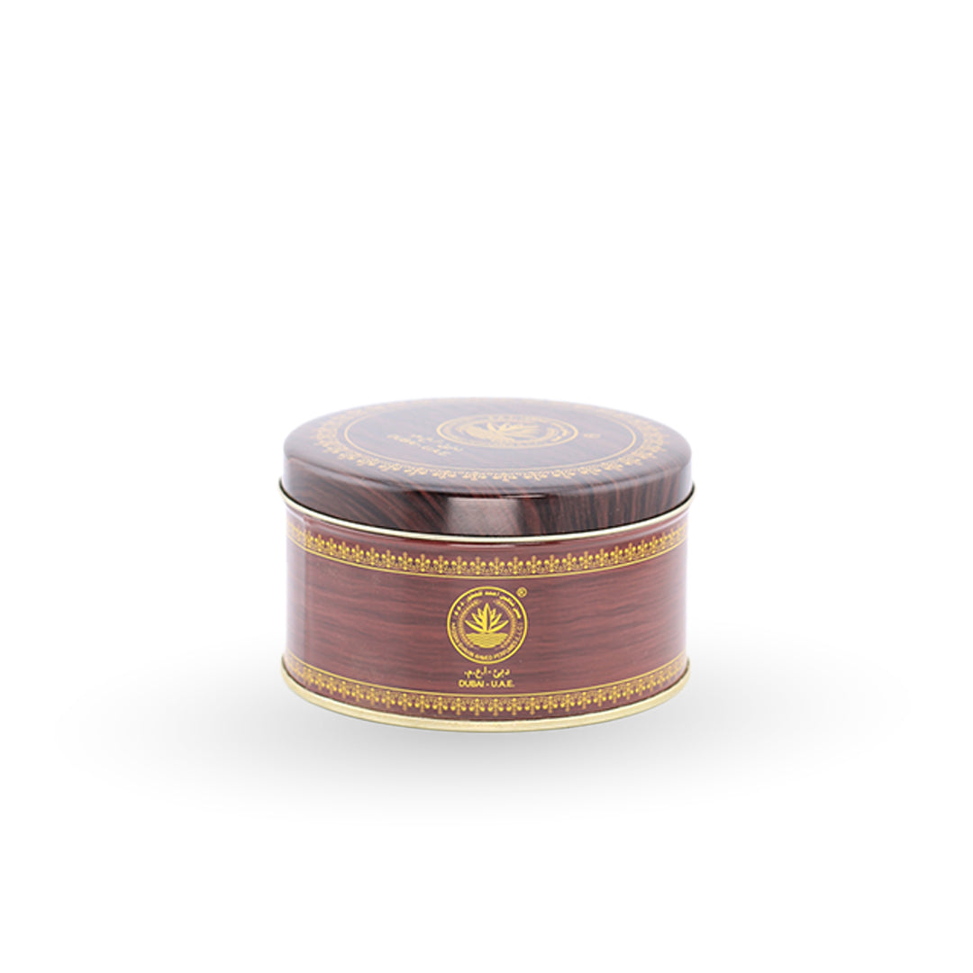 Round brown container with gold decorative elements on a white background