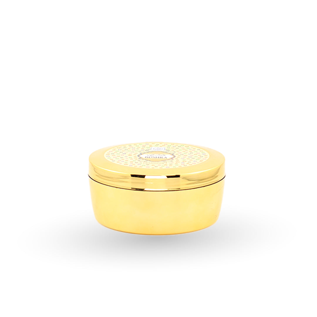 Gold decorative container with intricate design on a white background