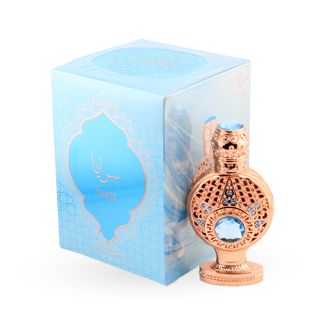 Decorative perfume bottle with intricate design next to its packaging on a white background