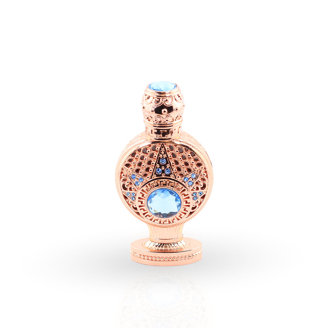 Rose gold decorative bottle with blue gemstones on a white background
