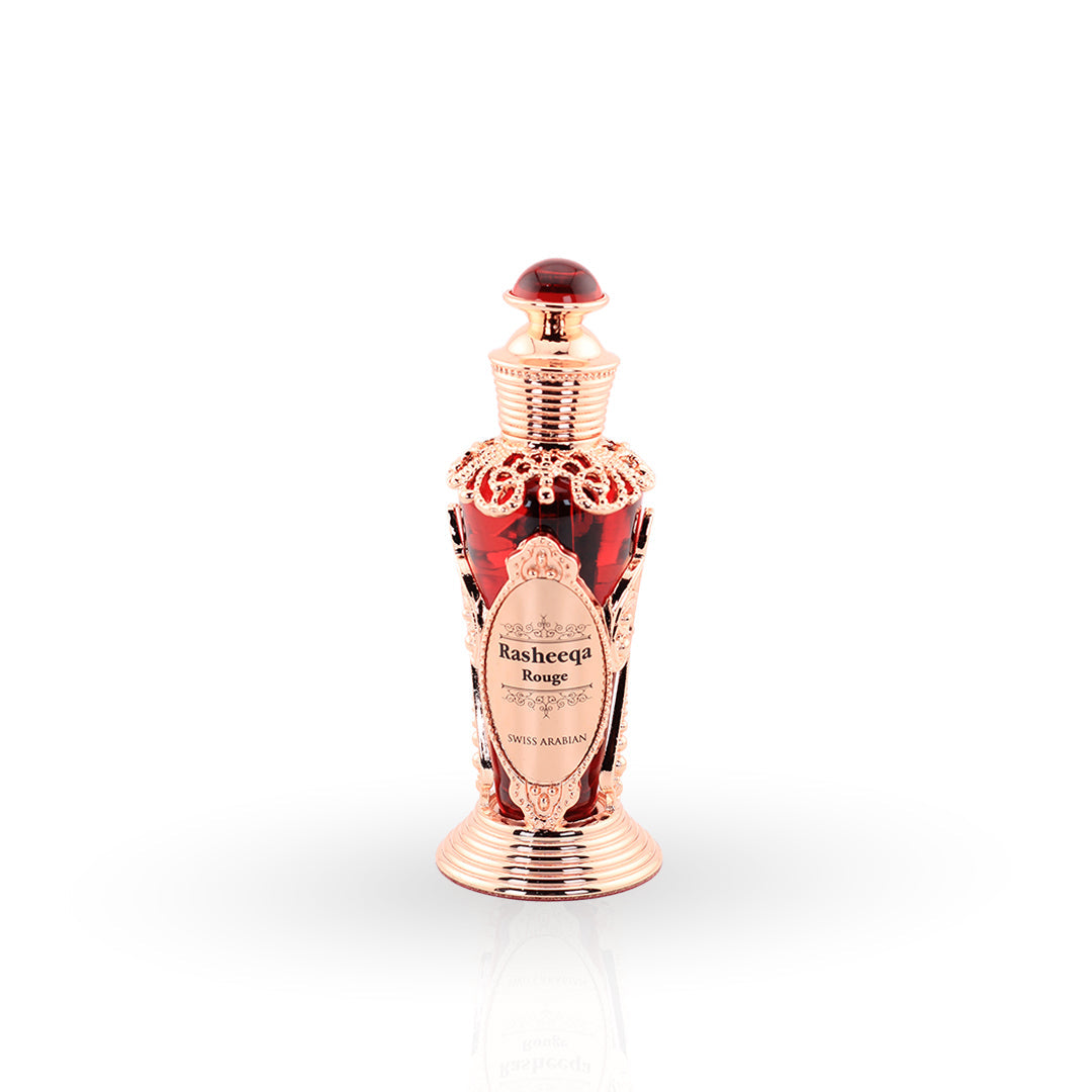 Perfume bottle with rose gold design and red cap on a white background