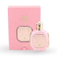 Pink perfume bottle with gold accents and matching box featuring 'Zu Khraf' branding on a white background.