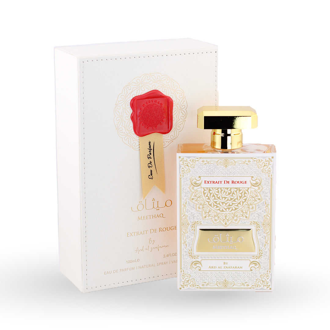 Perfume bottle and packaging with gold accents on a white background