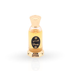 Gold and clear perfume bottle with 'Qisaty' branding on a white background