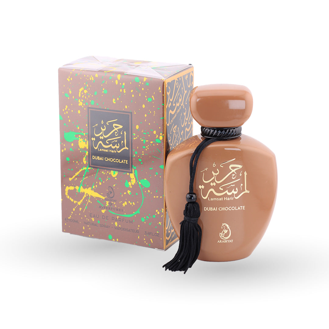 Brown perfume bottle with tassel and decorative box on a white background