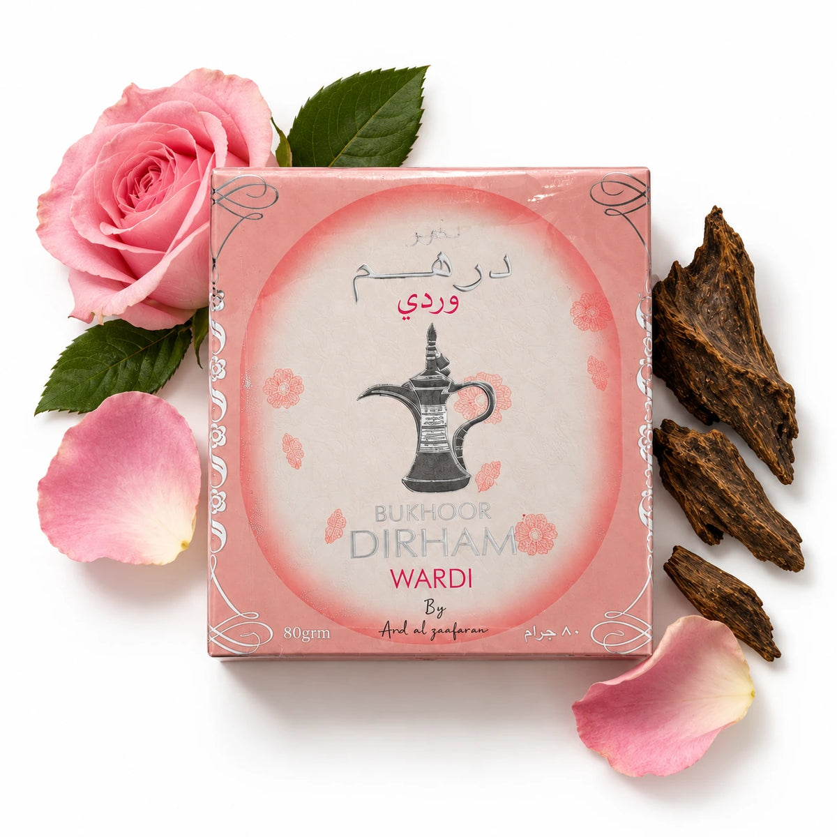 Ard Al Zaafaran Dirham Wardi 80g bakhoor box laid flat with rose petals and wood chips.