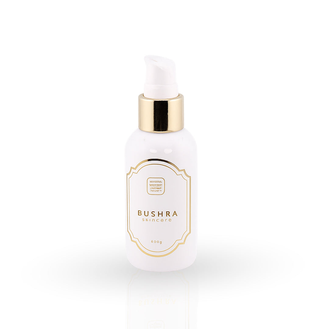 White skincare bottle with gold accents on a white background