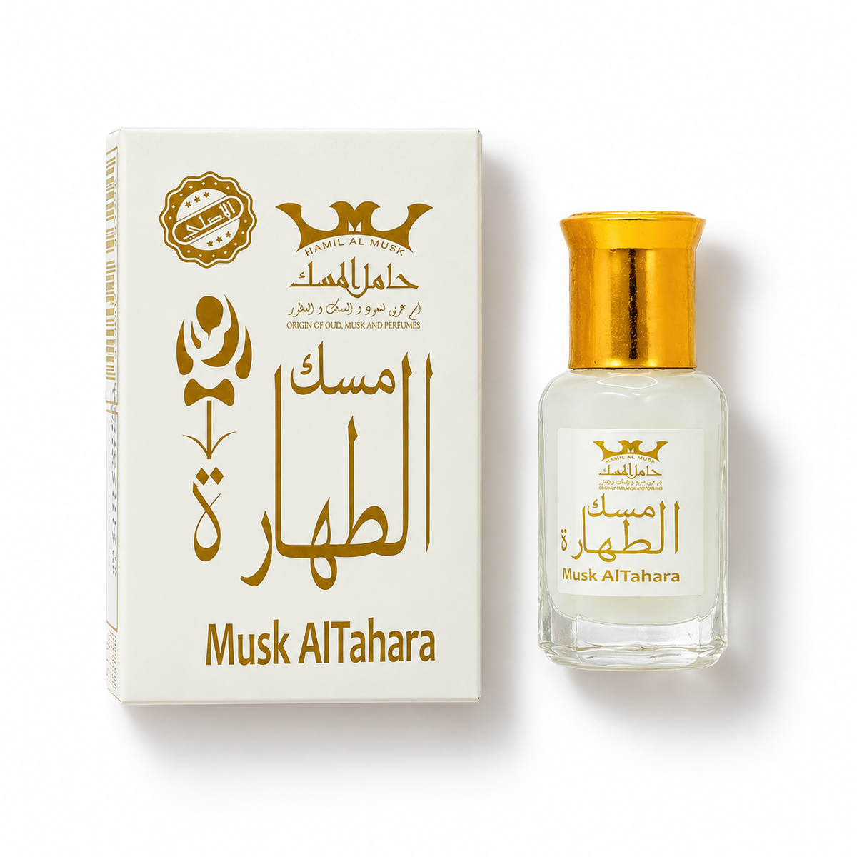 Hamil Al Musk Musk Al Tahara perfume oil bottle and white-and-gold carton laid flat on a white background.