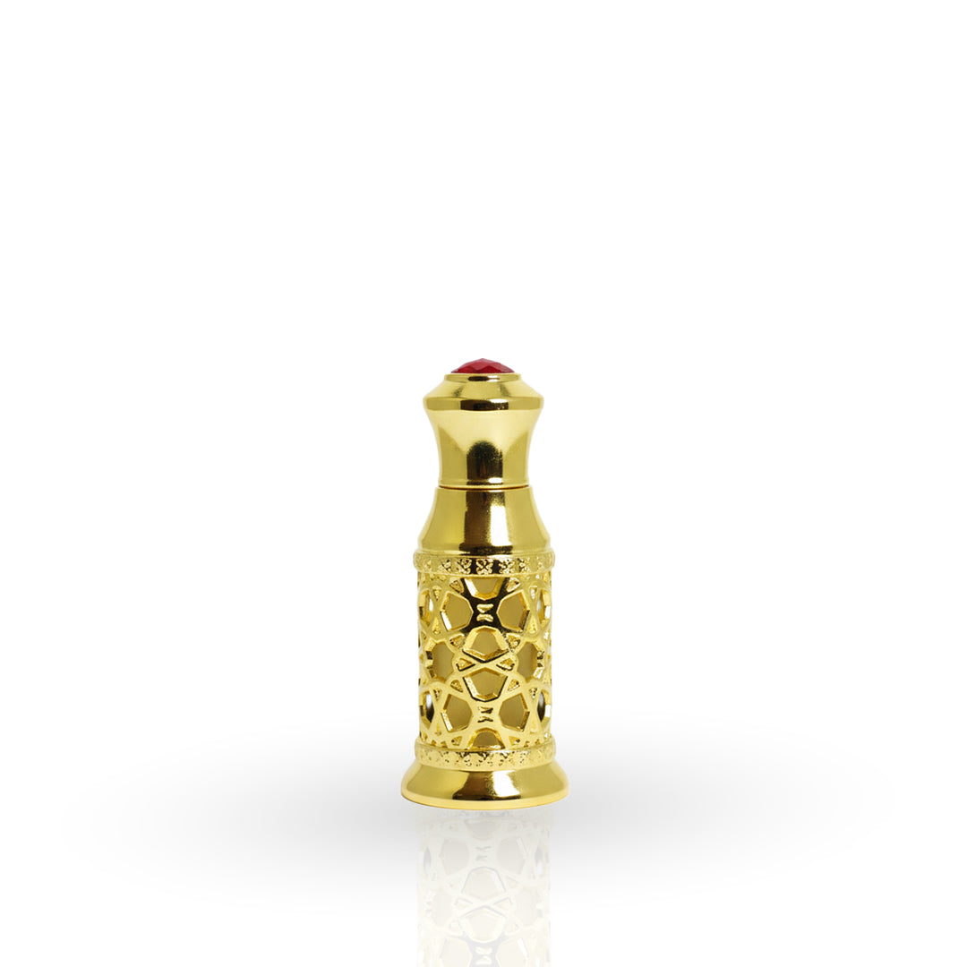 Gold decorative bottle cap with a red gemstone on a white background