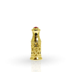 Gold decorative bottle cap with a red gemstone on a white background