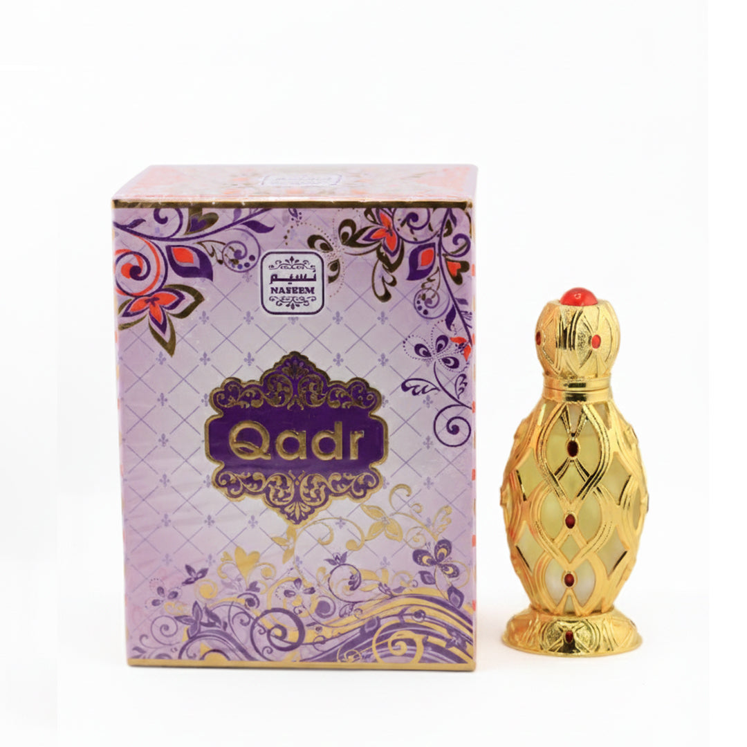 Gold perfume bottle with 'Qadr' branding next to its decorative box on a white background