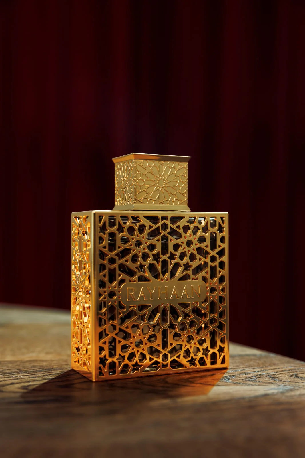 Rayhaan Elixir Eau de Parfum 100ml bottle in a dark red setting – unisex perfume, notes of lavender, vanilla and armoise