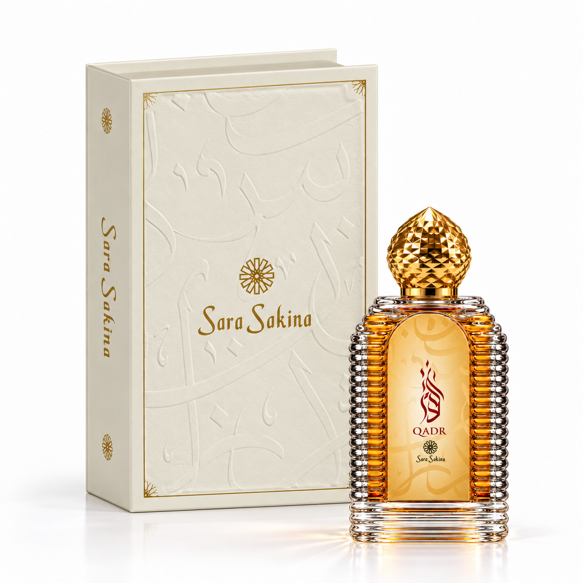 Qadr by Sara Sakina, ribbed amber 100ml bottle with the embossed ivory book-style presentation case and gold branded spine behind it