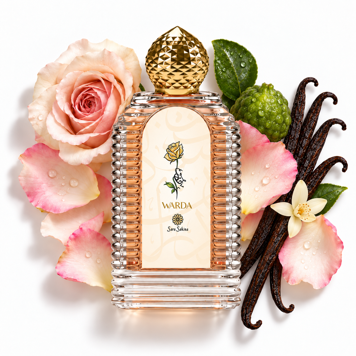Warda by Sara Sakina, 100ml extrait de parfum in a ribbed peach-filled glass bottle, with roses, vanilla pods and whole bergamot on a white flat lay