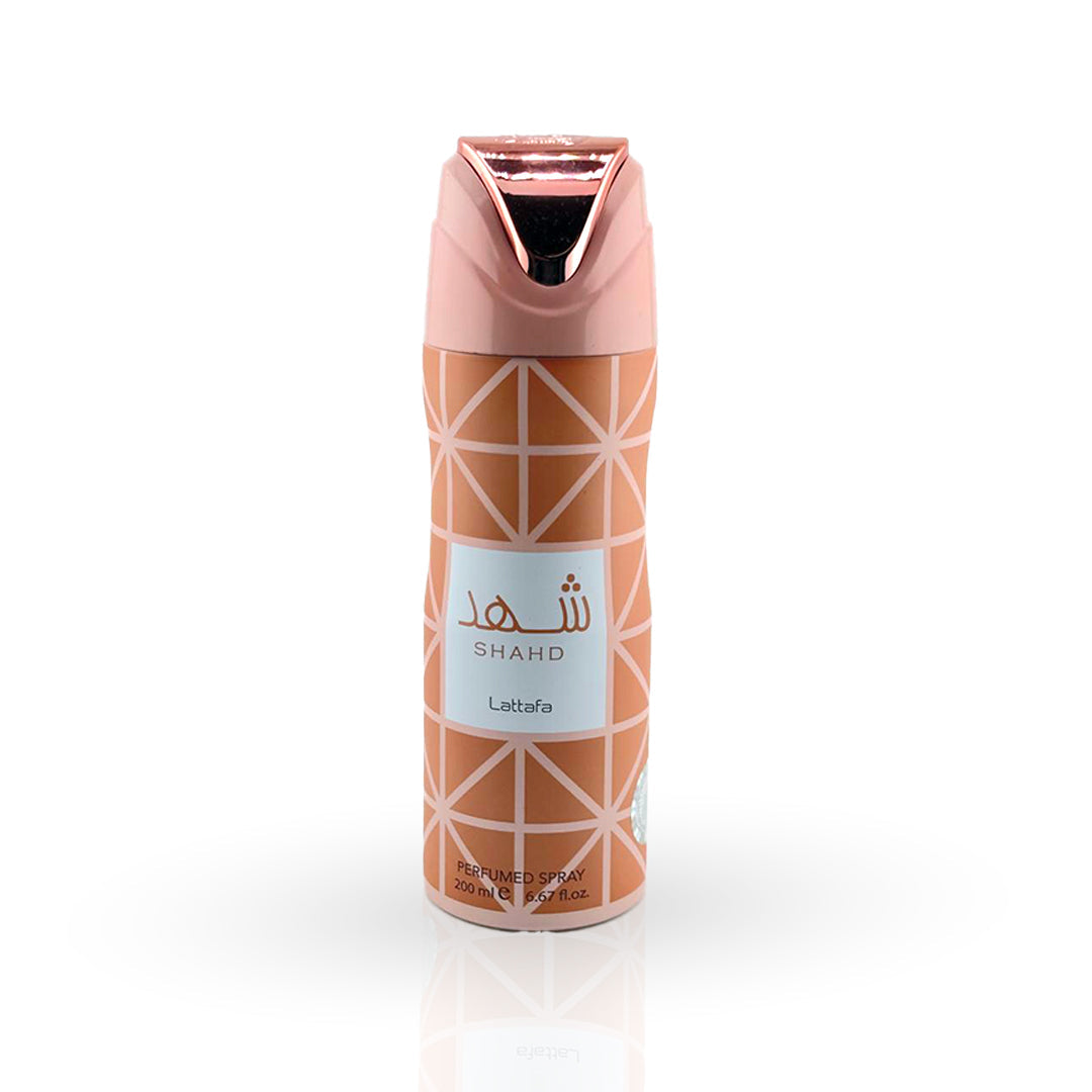 Perfume spray bottle with geometric design and pink cap on a white background