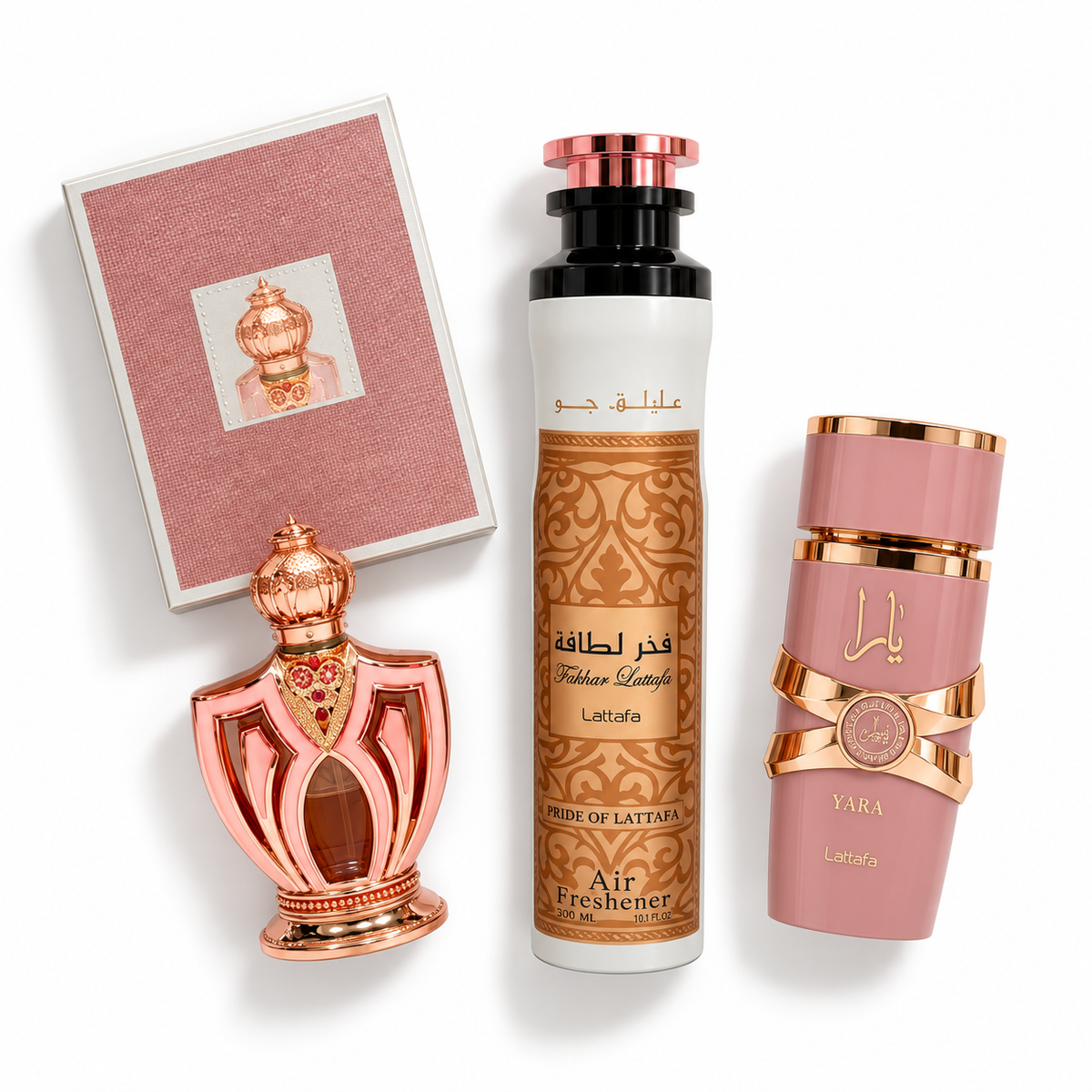 Yara perfume, Fakhar Lattafa air freshener and an ornate perfume oil bottle with its pink carton, arranged flat on a white background.